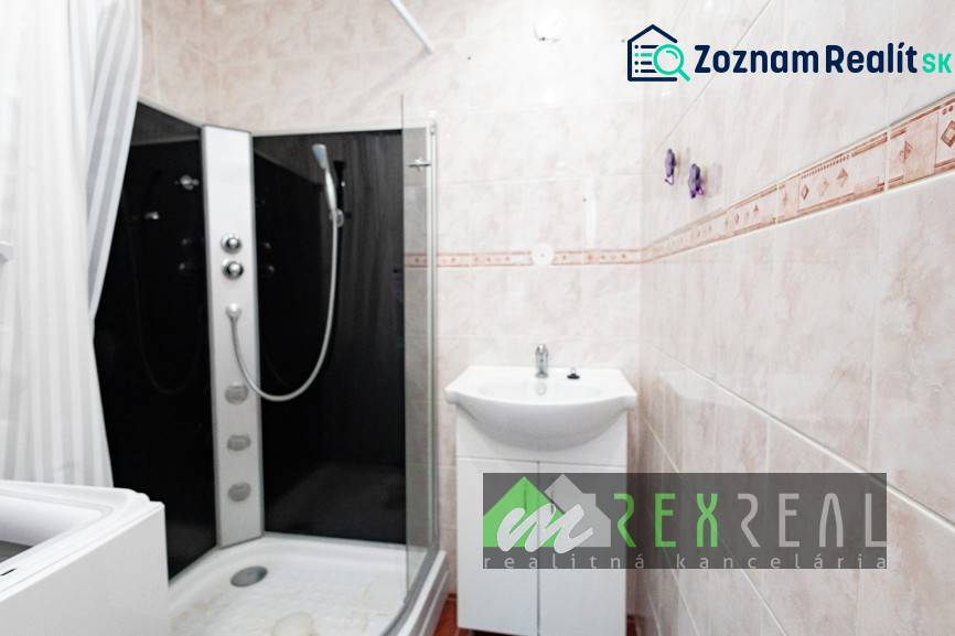 A bathroom in a 4-room apartment with a modern shower and a sink.