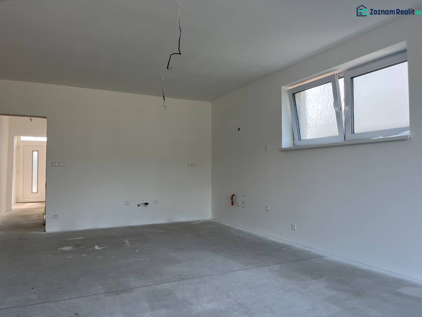 Interior of a family house with a window, white walls, and electrical installation operation.