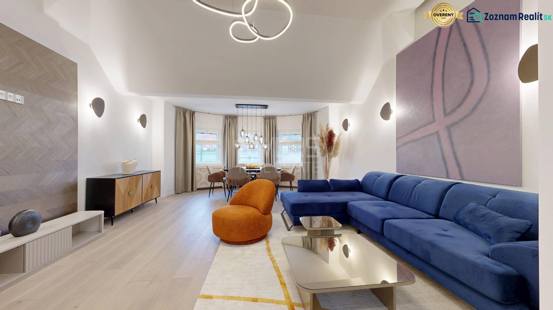 Stylish living room in a 4-room apartment with wood-patterned flooring and comfortable seating.