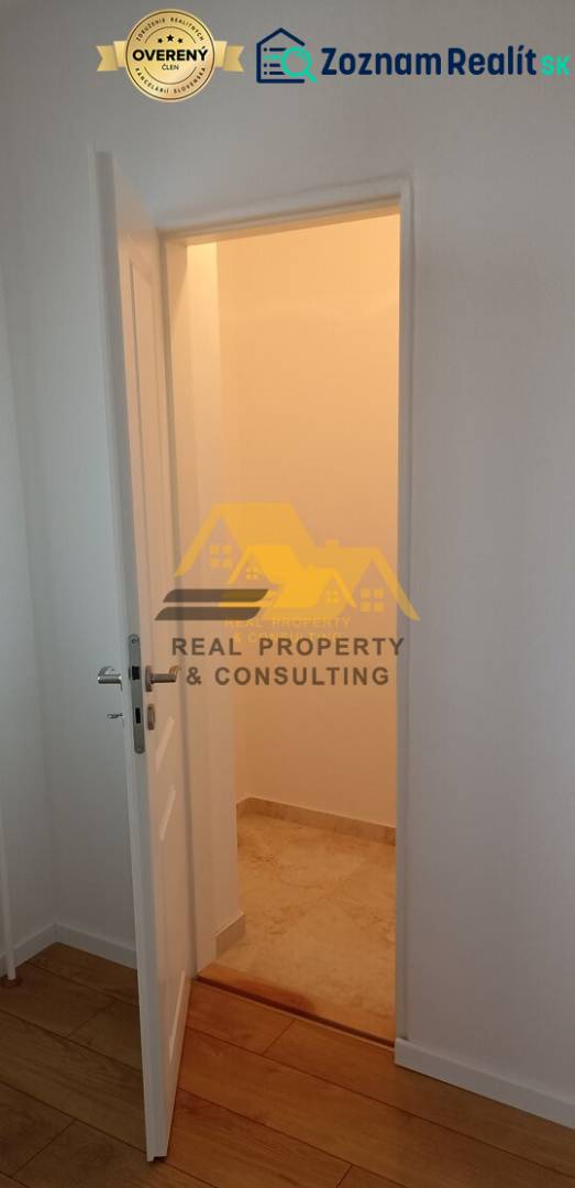 Interior of a 2-room apartment with open doors and a wooden decor floor.