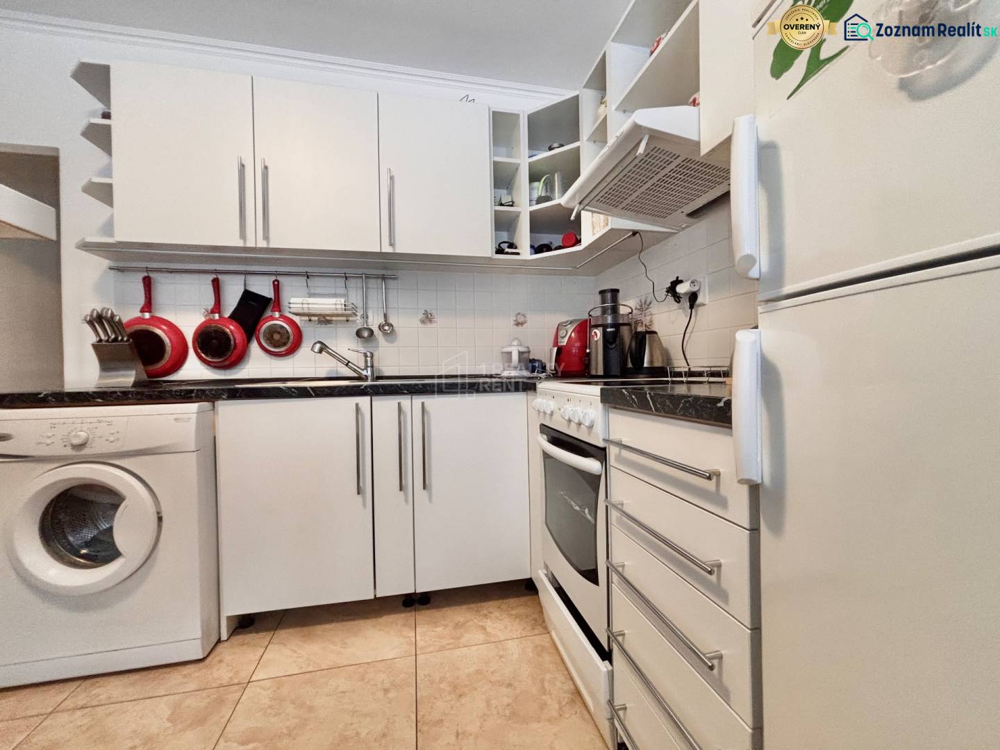 A kitchen with white cabinets, a dishwasher, a stove, and tiles in a two-room apartment.