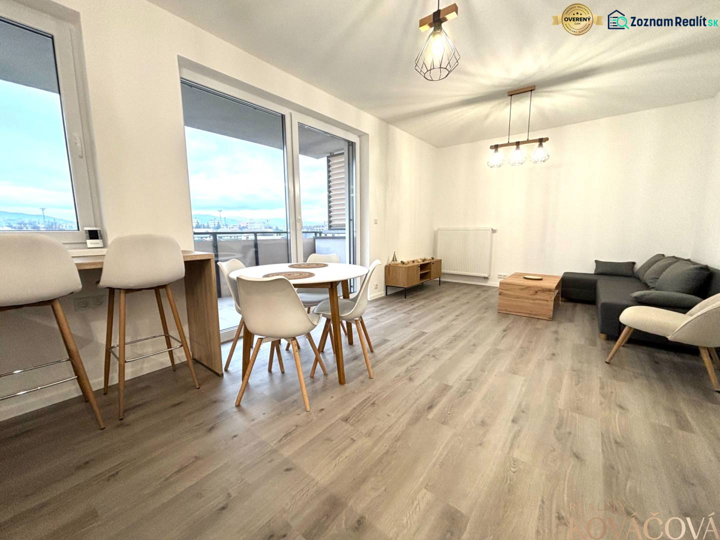 Living room in a 3-room apartment with a wooden decor floor and modern furniture.