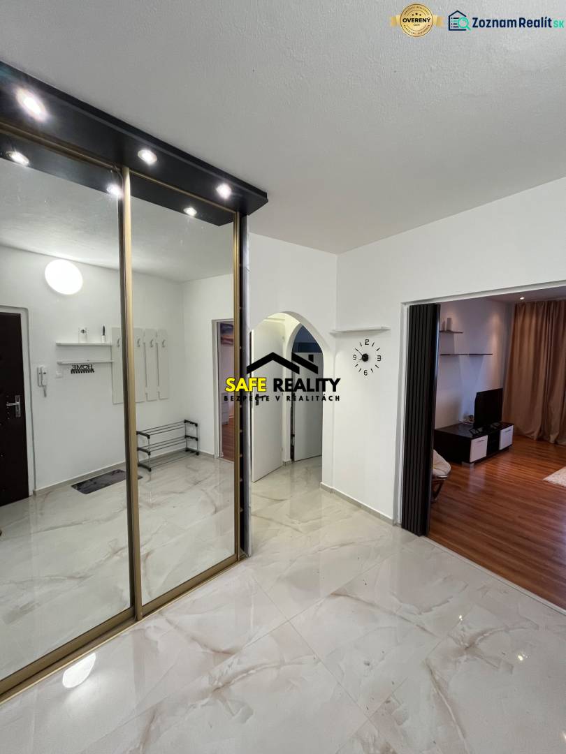 In the 3-room apartment, there is a mirrored wardrobe and a wooden decor floor in the living room.