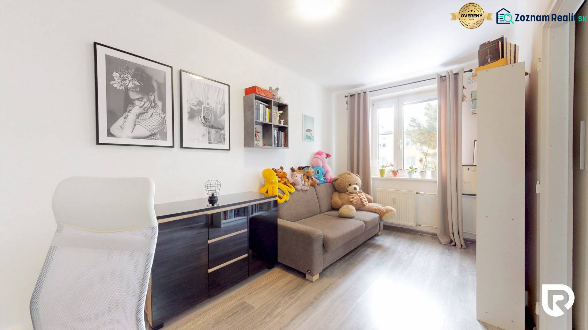Children's room in a 3-room apartment with a wooden decor floor and toys on the sofa.