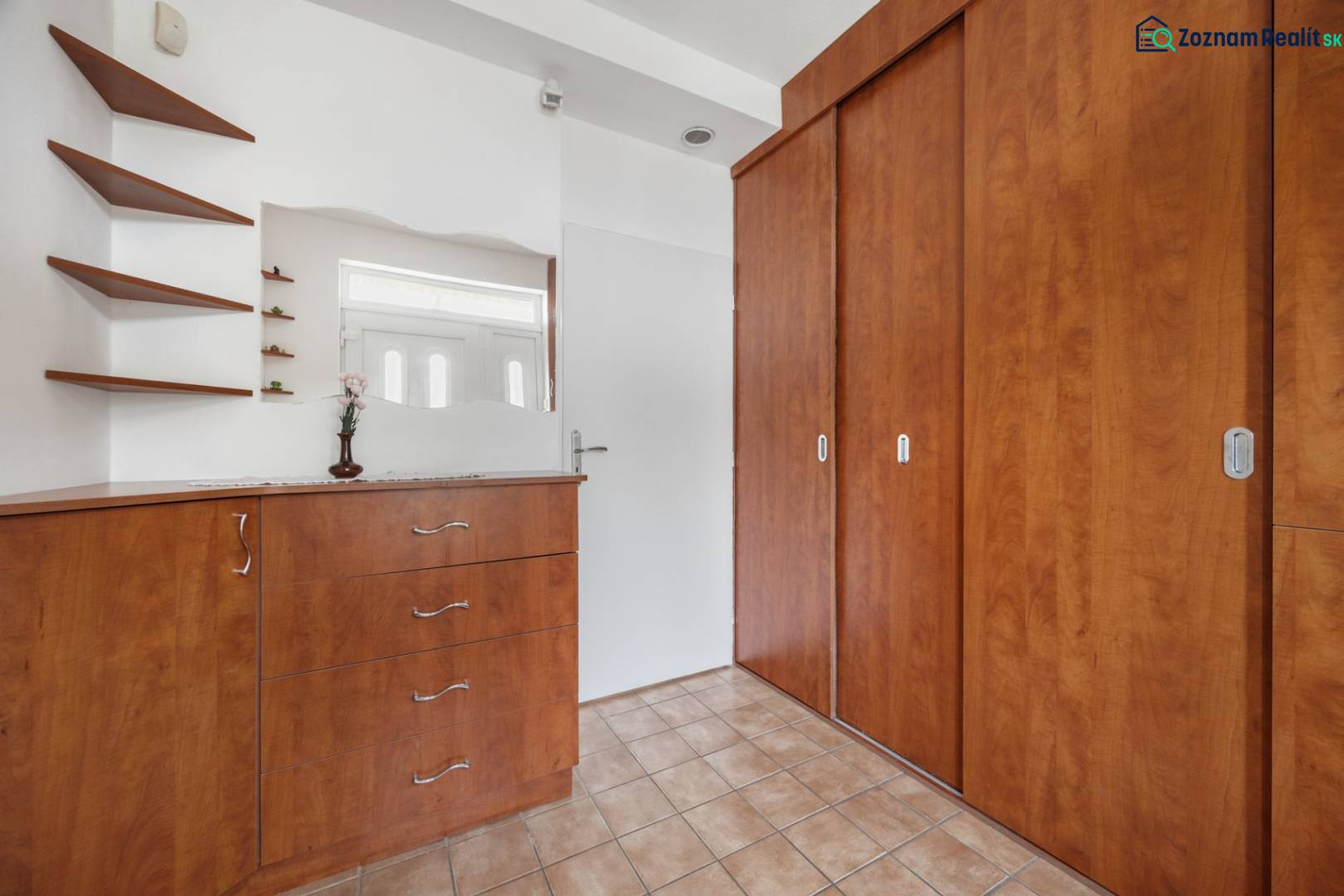 Built-in wardrobe and dresser in a family house with a wooden decor.