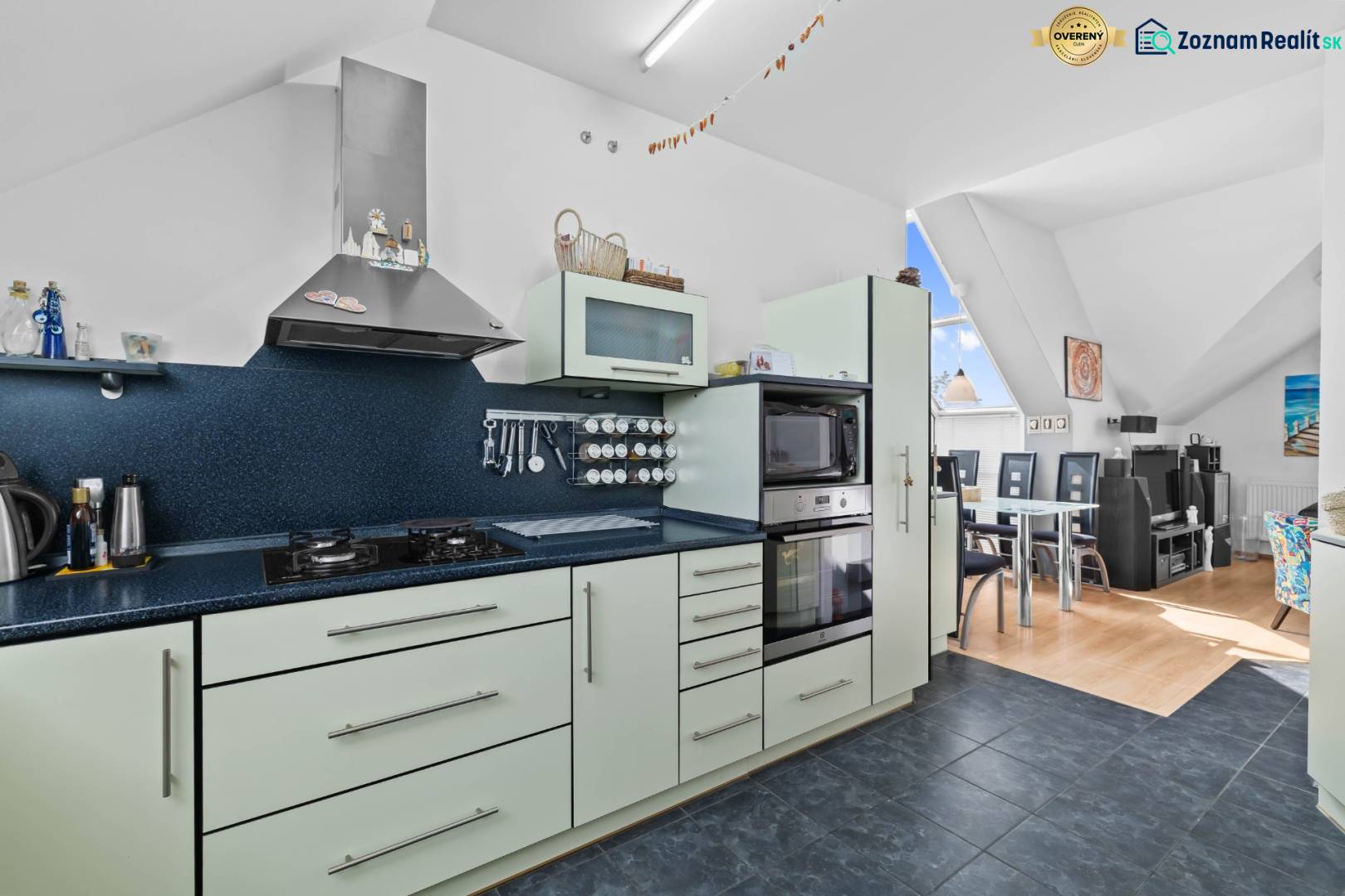 A kitchen in a family house with an oven, stove, and dining area.