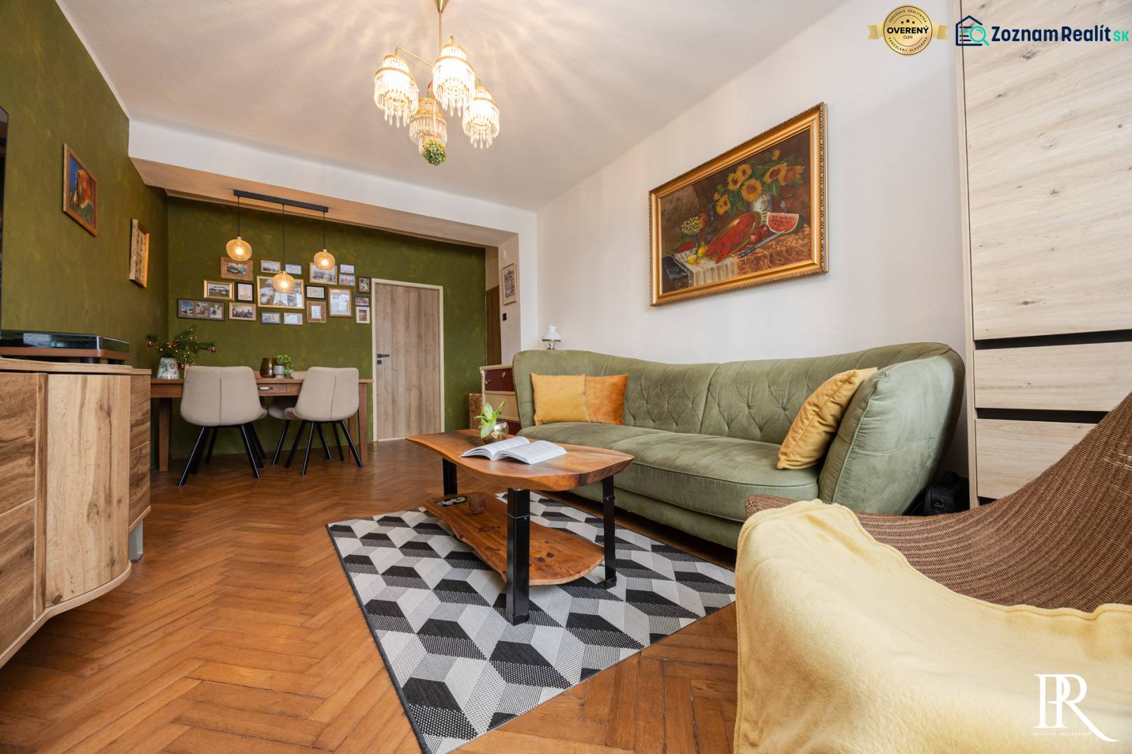 Living room with a sofa, a painting on the wall, and a floor with a wooden decor.