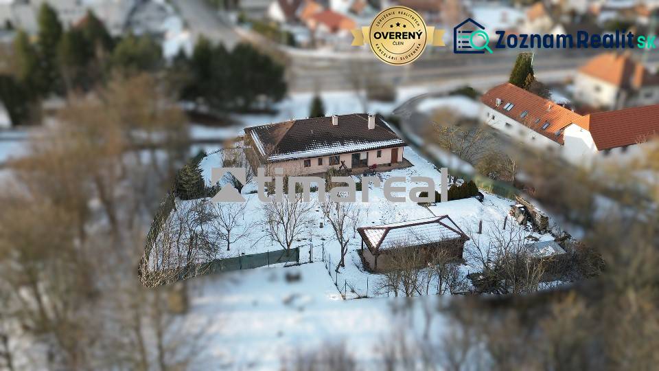 A snowy family house in Myjava with a large yard and a wooden gazebo.