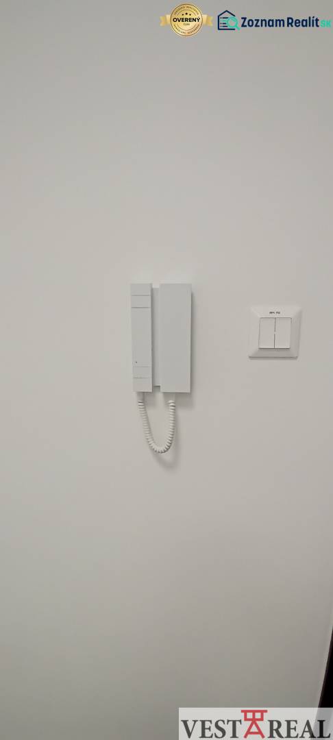 White door with intercom and switch in the office.