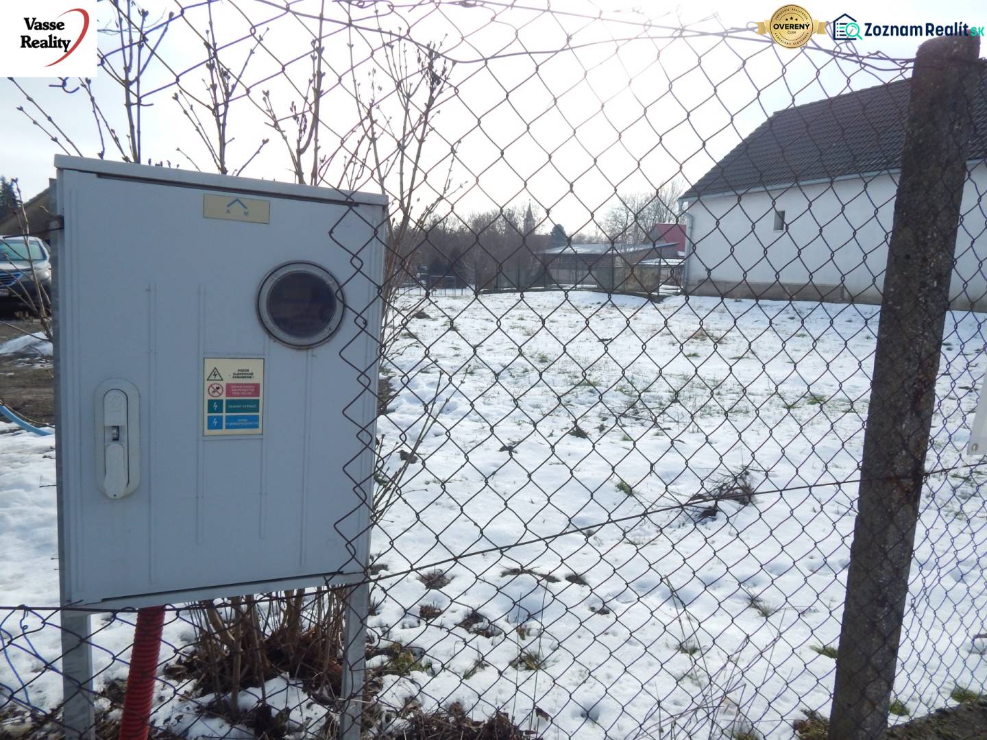 A fenced plot in Čalovec designated for housing, snowy surface, and an electrical box.