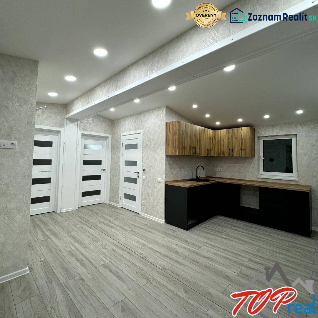 Interior of a family house with a wooden decor floor and a stylish kitchen unit.