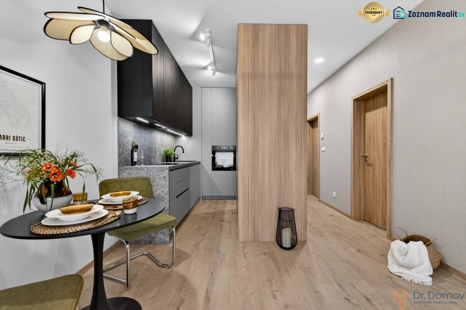 A kitchen in a 2-room apartment with a wooden decor floor, a dining table, and interesting lighting.