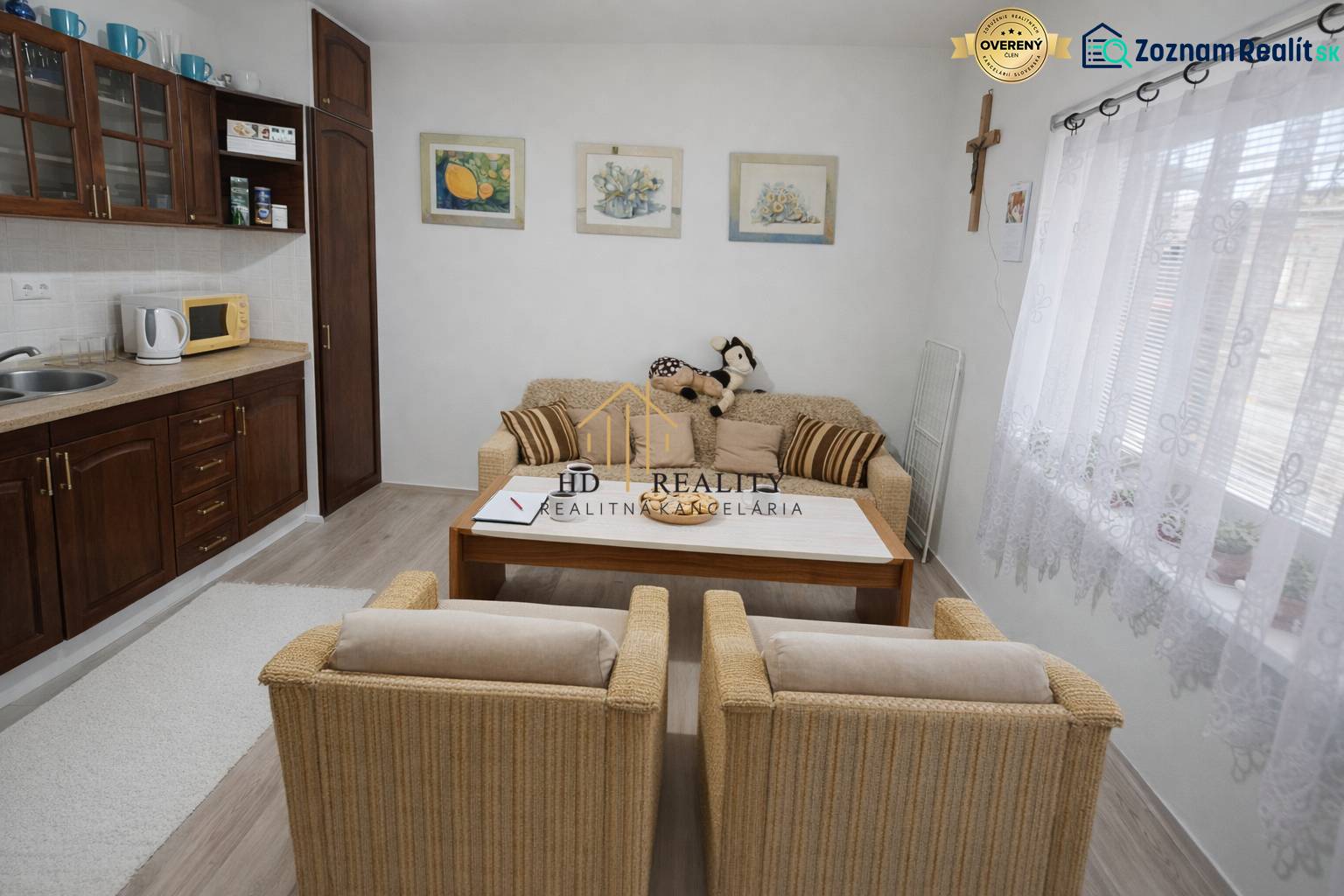 Family house with a cozy living area, kitchen, decorative paintings, and wooden decor flooring.