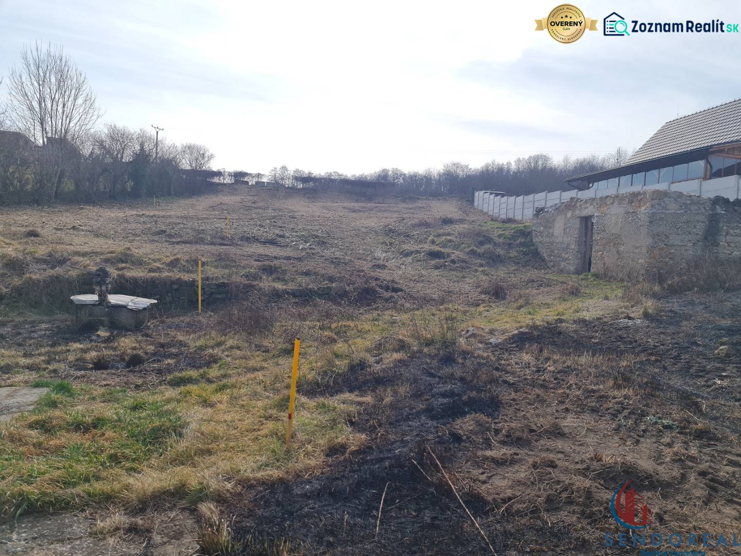 Plots - housing on Poľná Street in Banka, with grassy and overgrown areas.