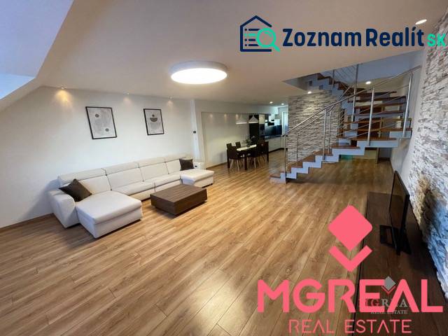 Living room in a 3-room apartment with a wooden decor floor and a designer staircase.