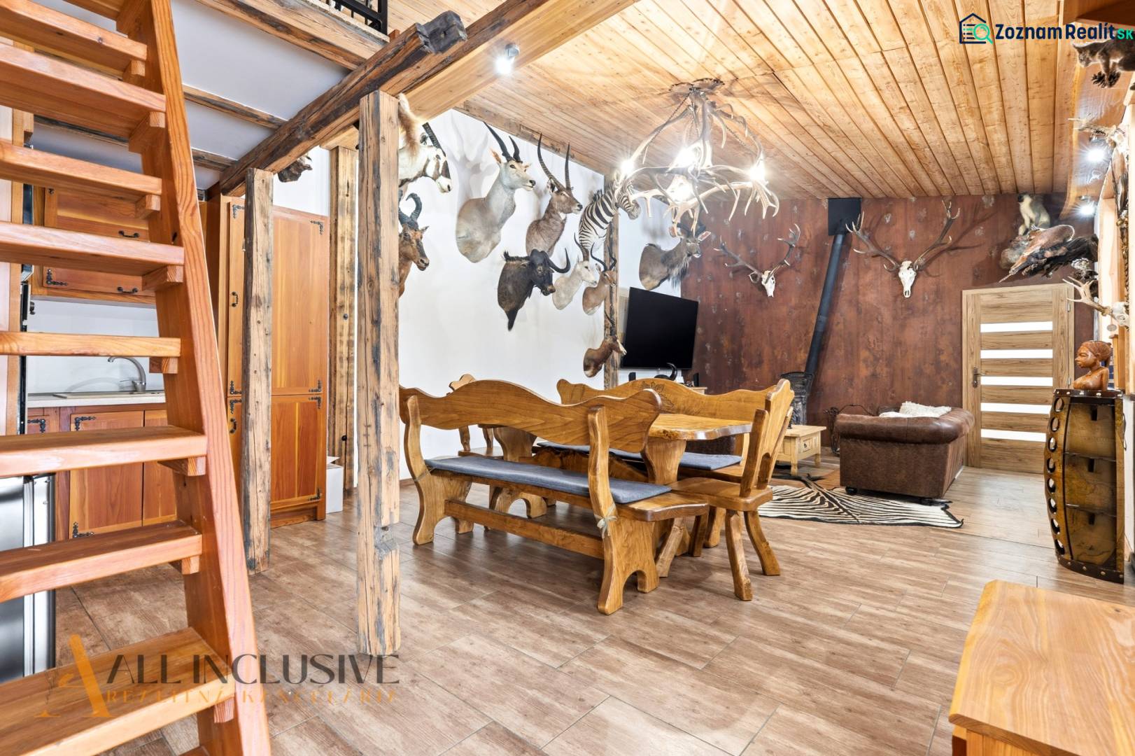 Interior of a family house with wooden stairs, hunting trophies, and a floor with a wooden decor.
