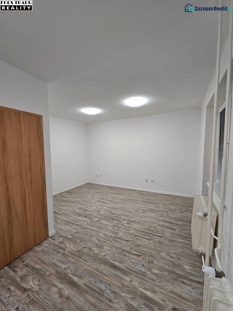 Offices with wood-patterned flooring, white walls, and wooden doors.