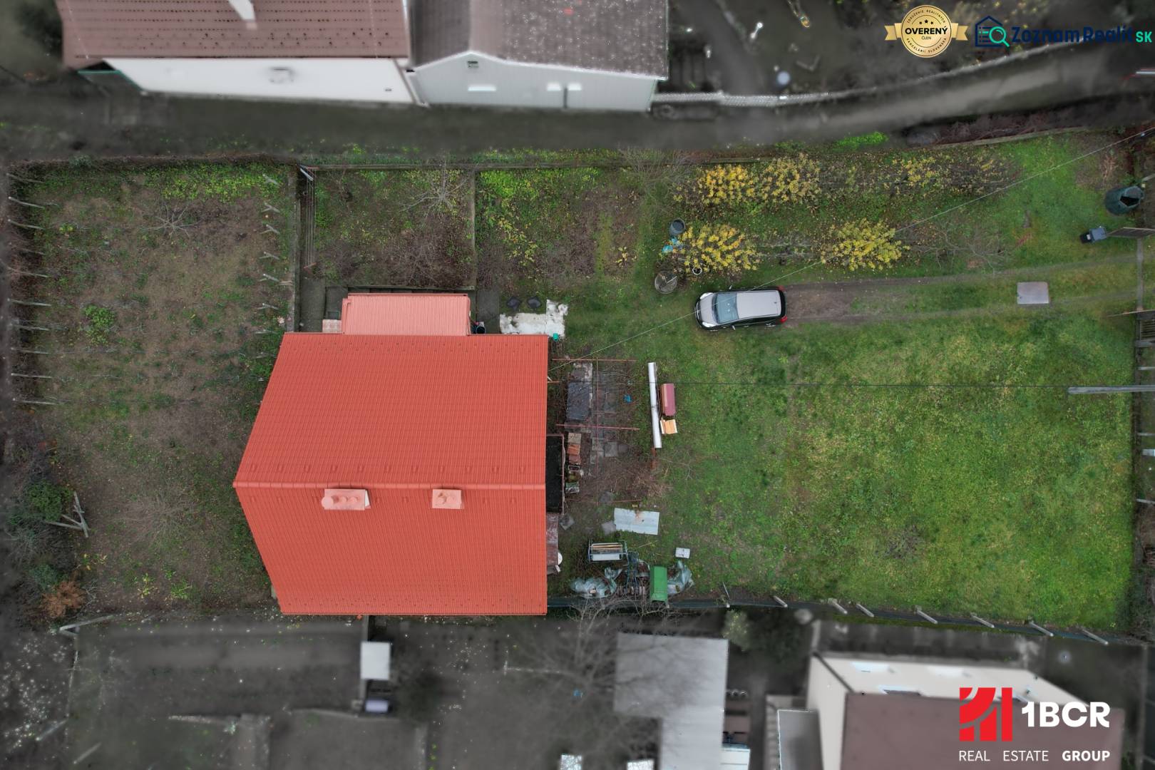 A family house in Podhradie in Svätý Jur with a red roof and a green garden.