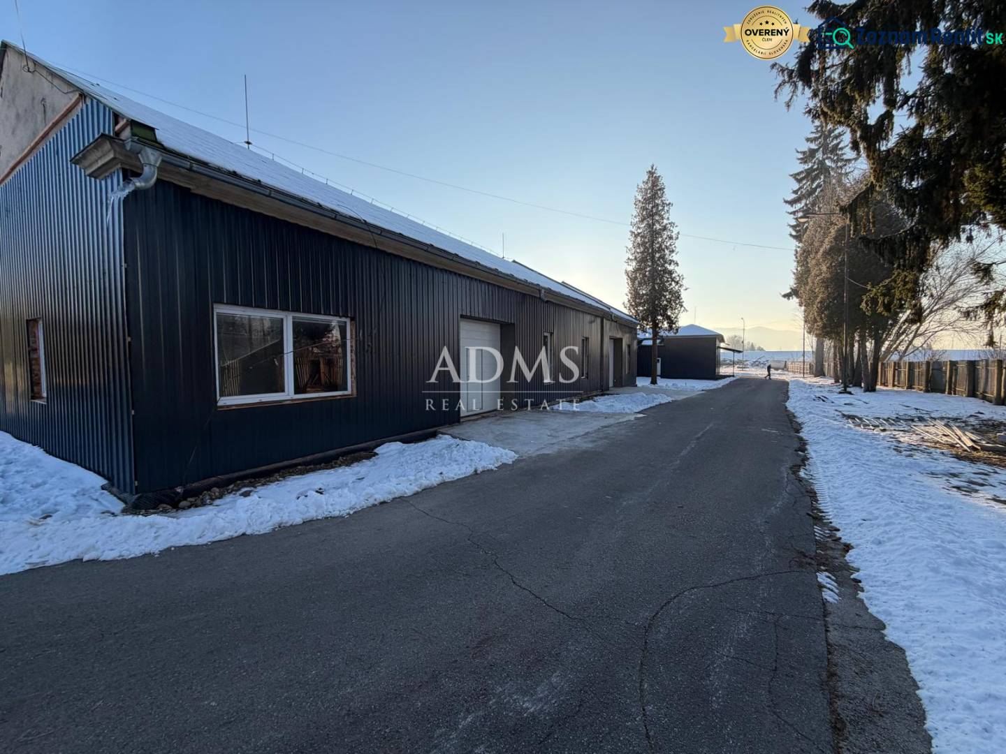 The road by the warehouses and halls on Pšurnovická Street in Bytča covered with snow.