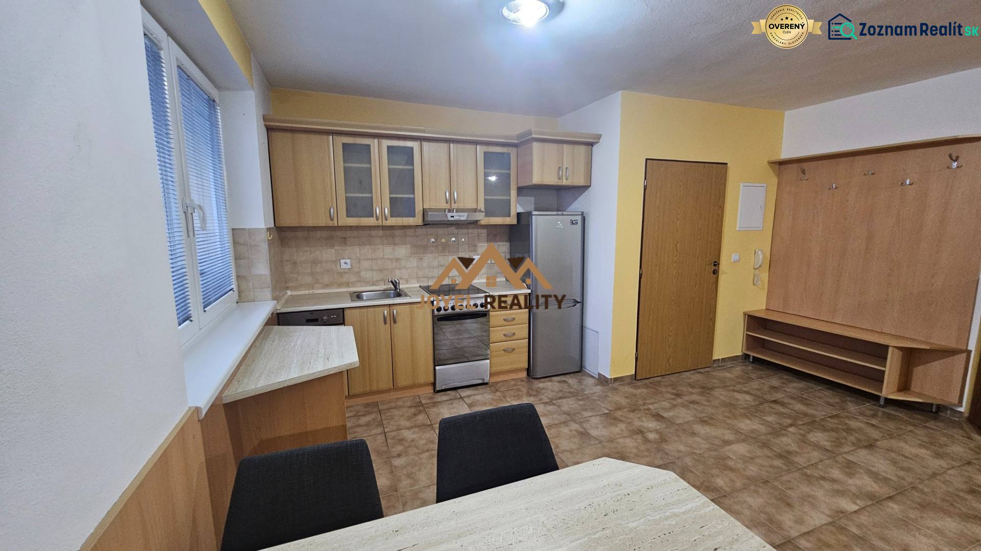 A kitchen in a 3-room apartment with wooden decor and ceramic tiles.