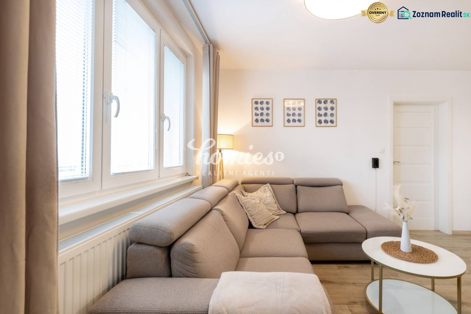 Living room in a two-room apartment with a comfortable sofa and wall decorations.