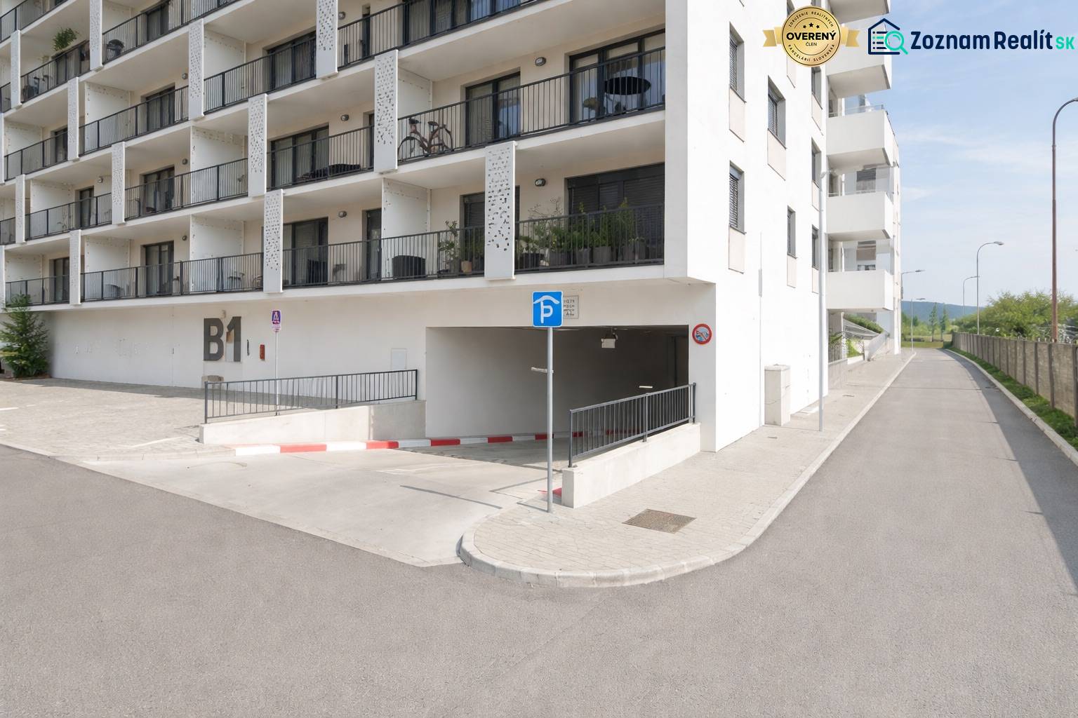 Residential building with parking entrance in Bratislava-Rača on Eduarda Wenzla Street.