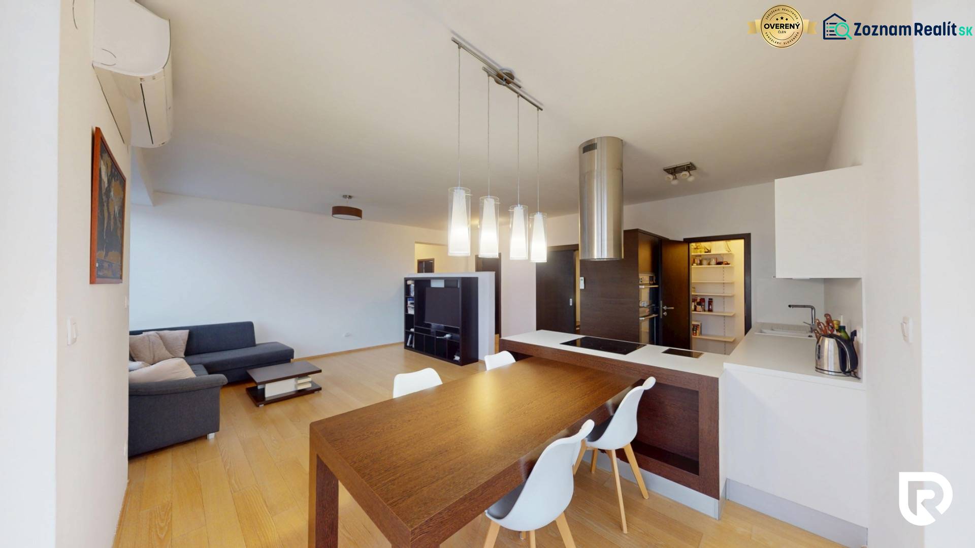 Open kitchen and dining area in a 4-room apartment with wood-patterned flooring.