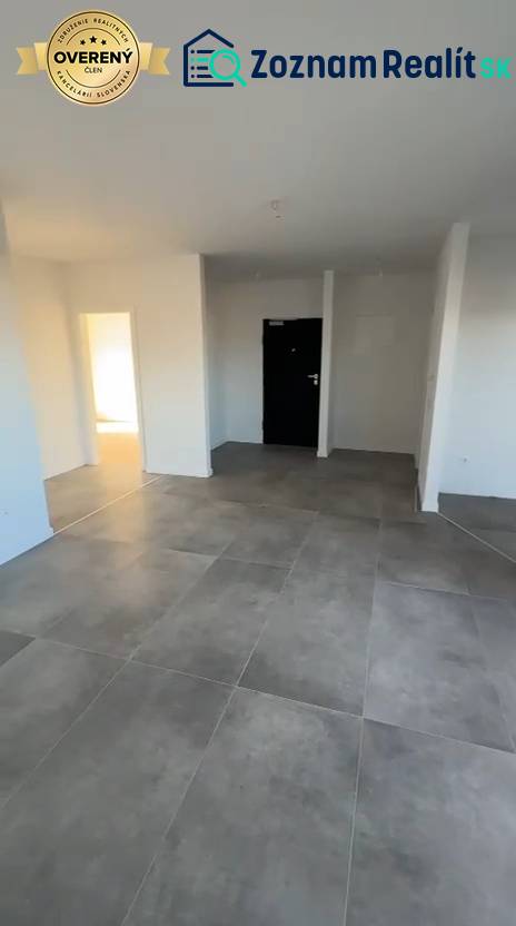 Interior of a 3-room apartment with large tiles and white walls.