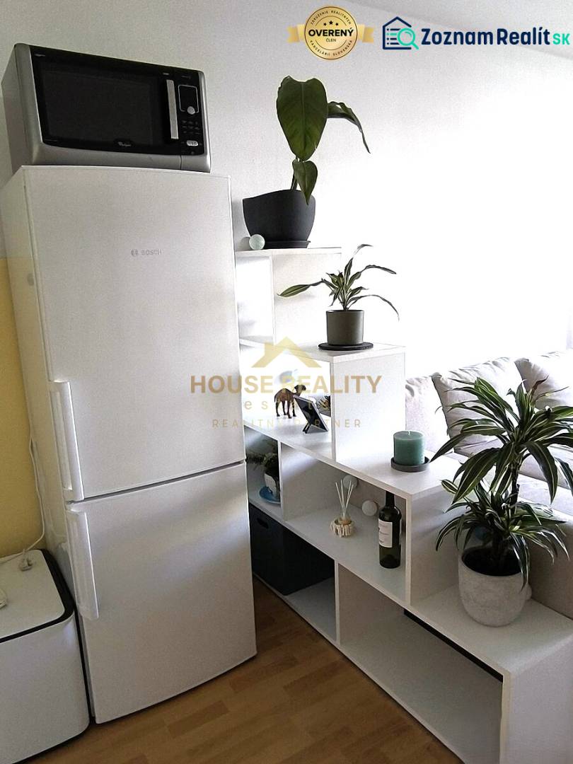 Interior of a 2-room apartment with a stylish white shelf and a floor with a wood decor.