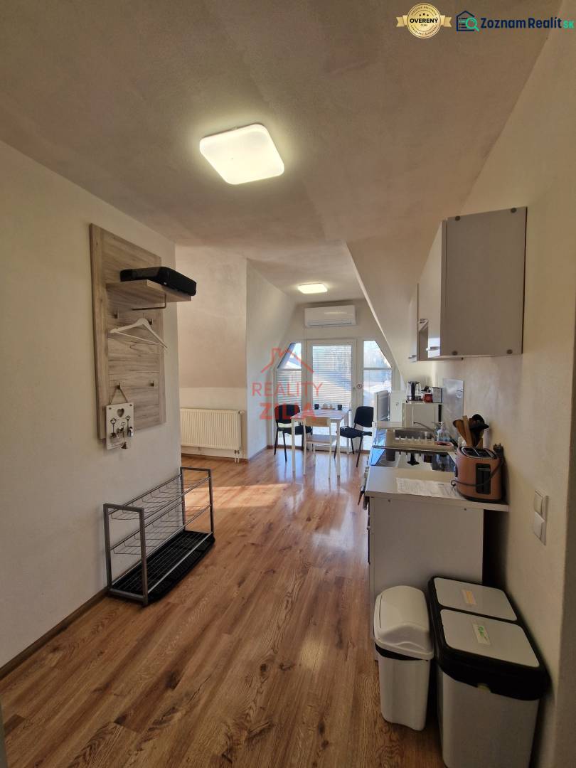 Interior of a family house with a kitchen and dining area, floor with wooden decor.