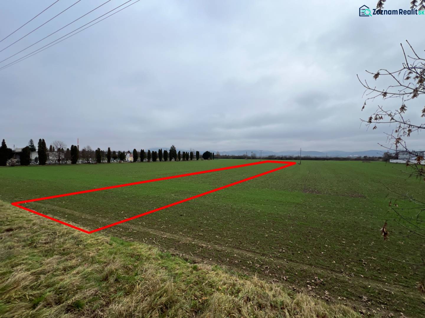 Green commercial land in Pruské, bordered by a red line in the photograph.