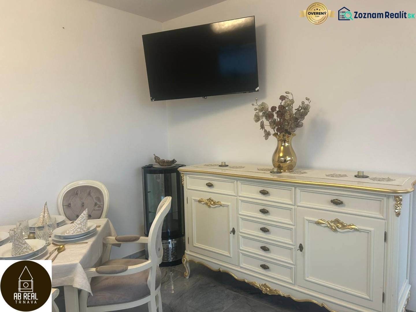 Elegantly furnished interior of dining spaces with a television on the wall and decorated furniture.