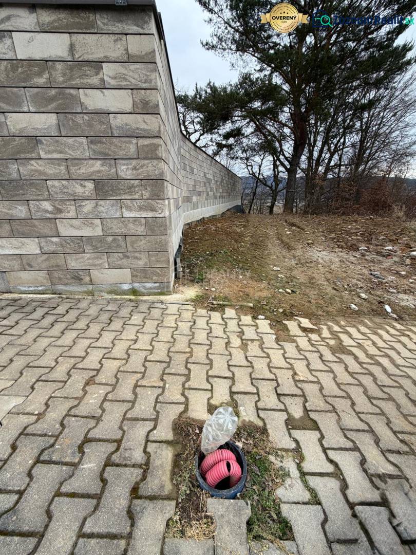 A brick fence and concrete paving on residential plots in Veľká Bytča.