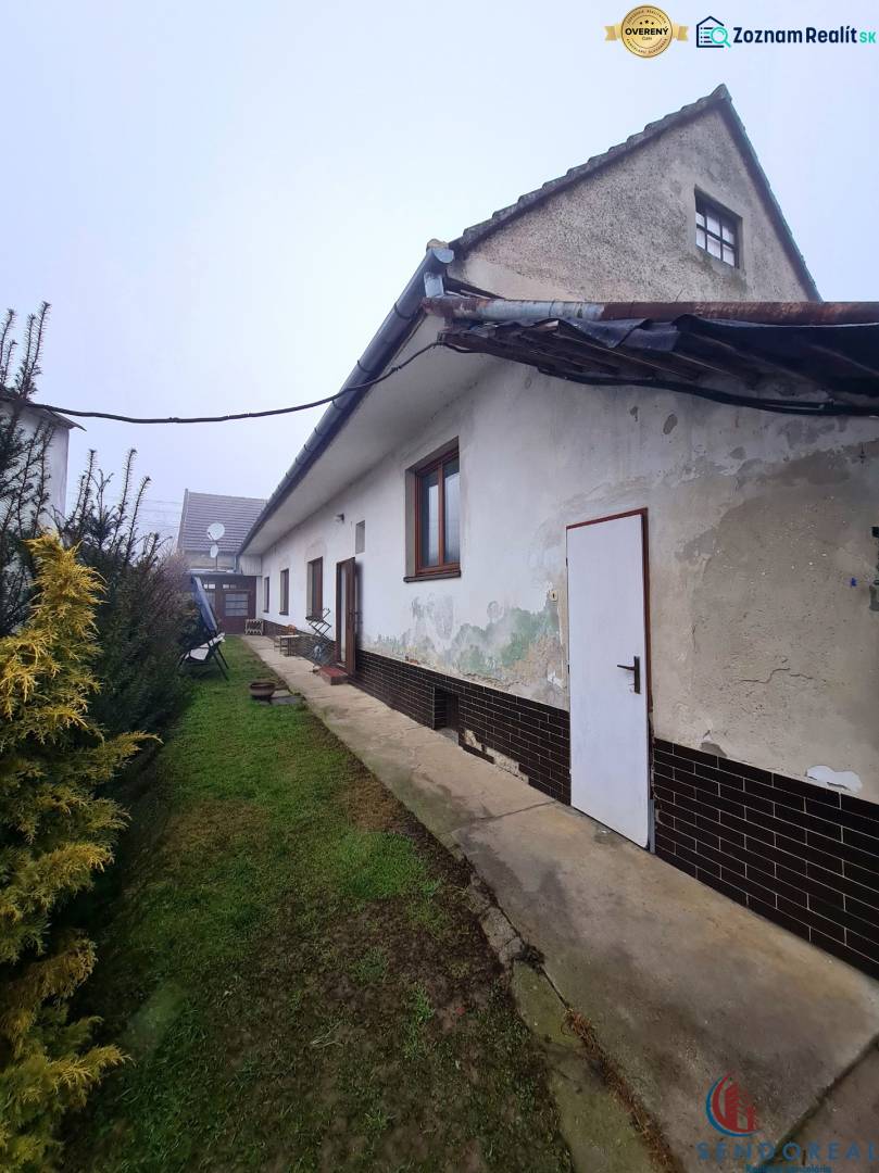 Family house on Námestie 1. mája in Chtelnica with a grassy yard and garden greenery.