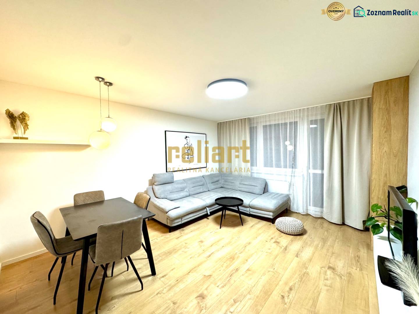 Living room in a 3-room apartment with a wooden decor floor, a sofa, and a dining table.