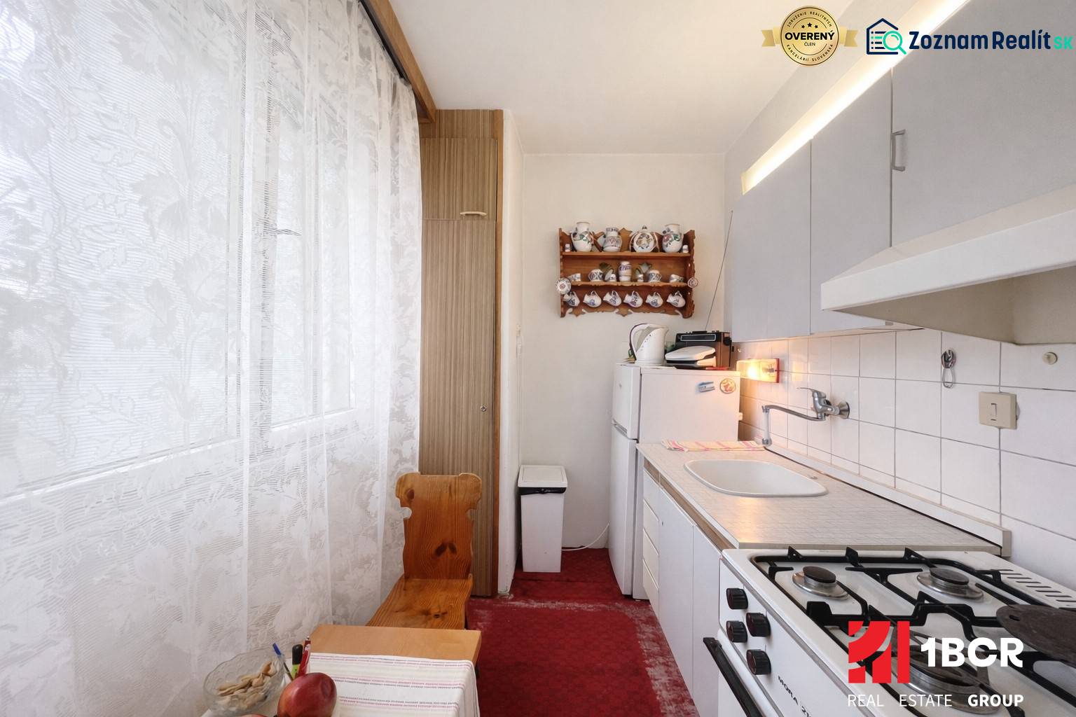 Cozy kitchen with a gas stove and rustic decor in a studio apartment.