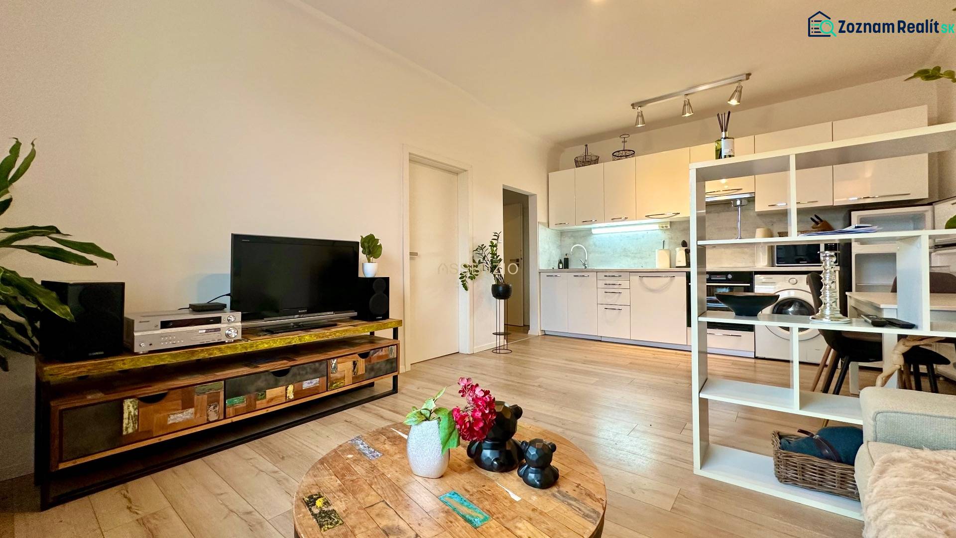 Living room in a two-room apartment with a wooden decor floor, tastefully furnished and cozy.