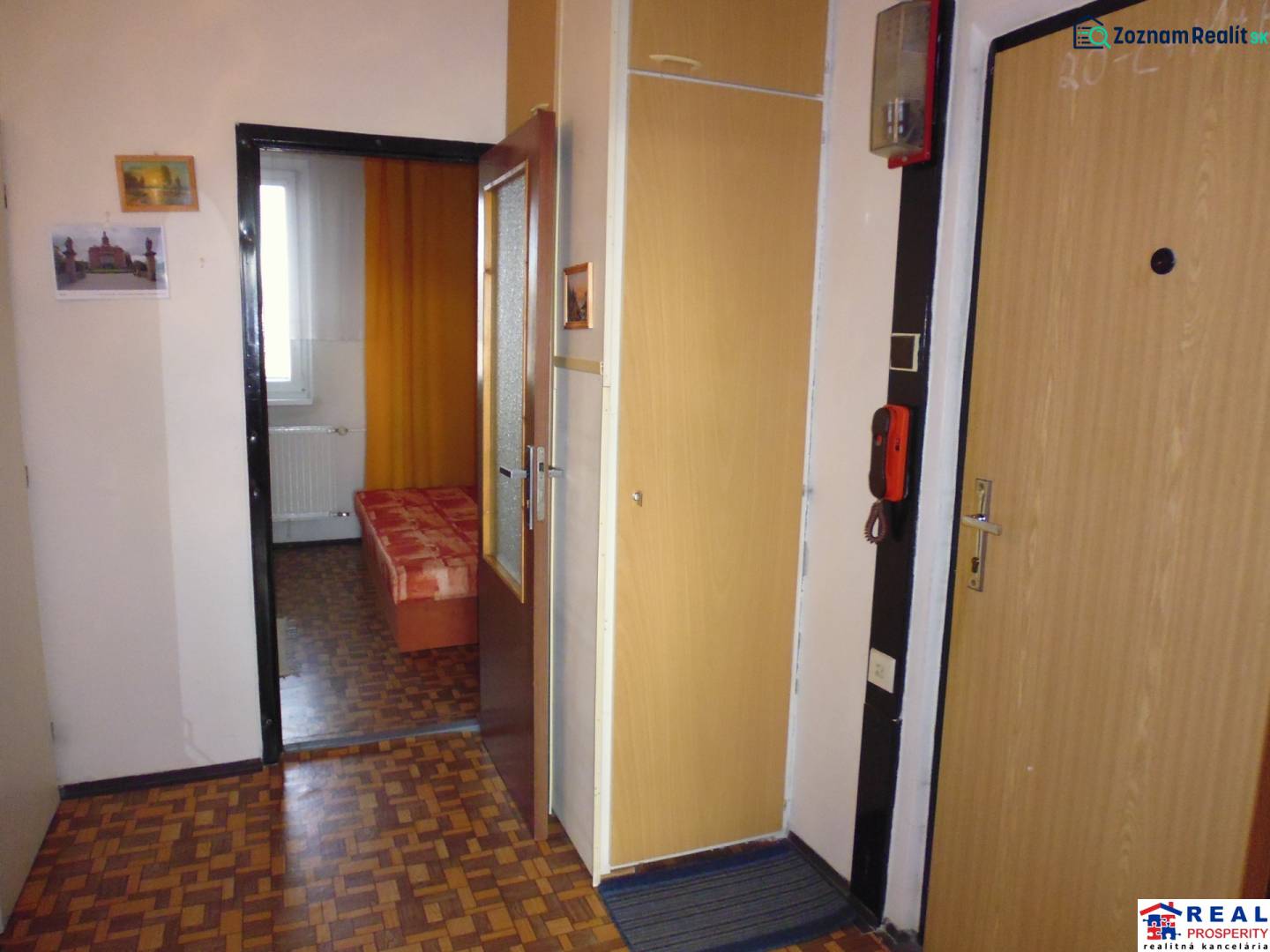 Interior of a 1-bedroom apartment with a wooden decor floor and simple furnishings.