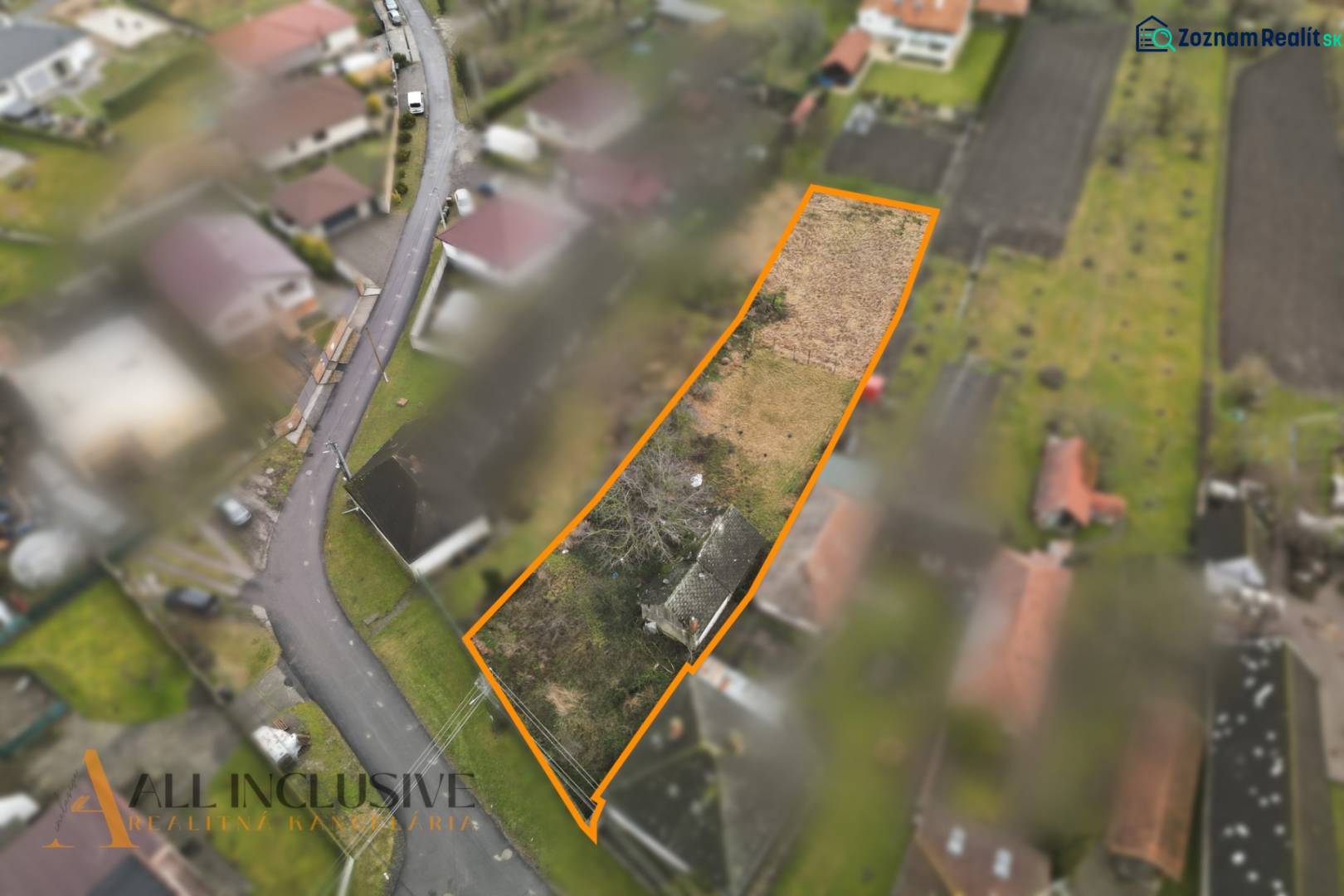Aerial view of plots - housing in Holice with a garden and a road.
