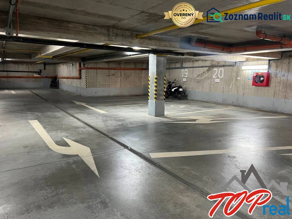 Underground garage with parking spaces, markings, and a motorcycle, Košice - Staré Mesto district.