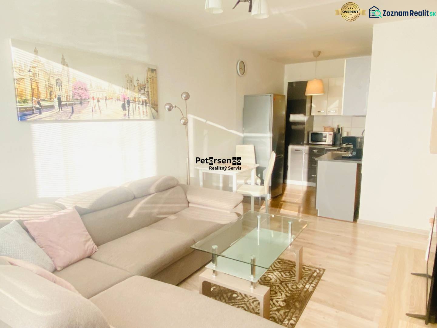 Living room with a sofa and kitchen, 2-room apartment, floor with wood decor.