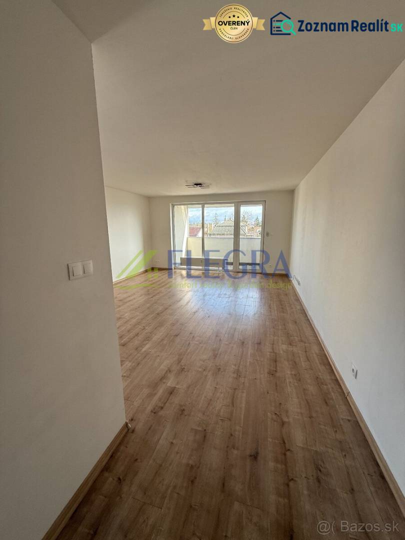 A bright living room with wood-patterned flooring in a two-room apartment.