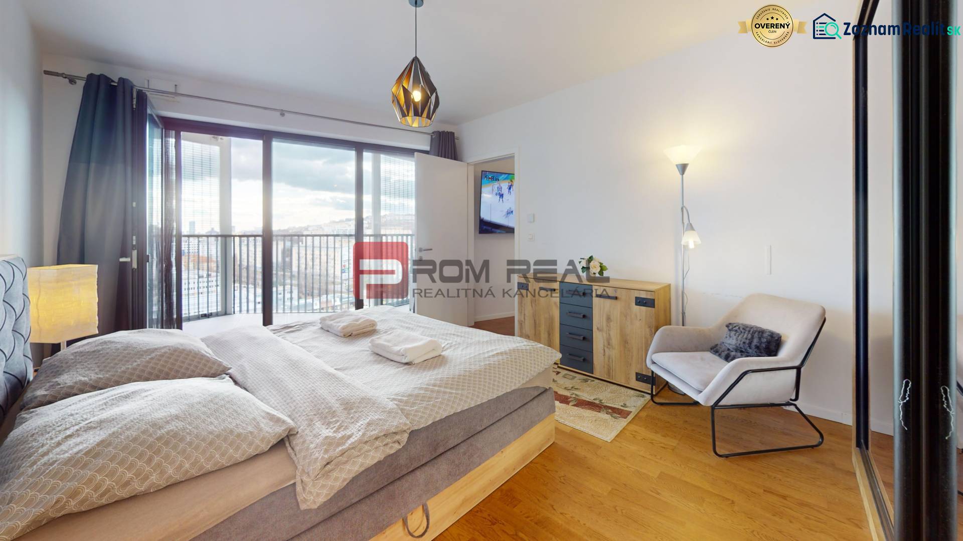 Bedroom with a large bed, armchair, and wardrobe, floor with wooden decor.