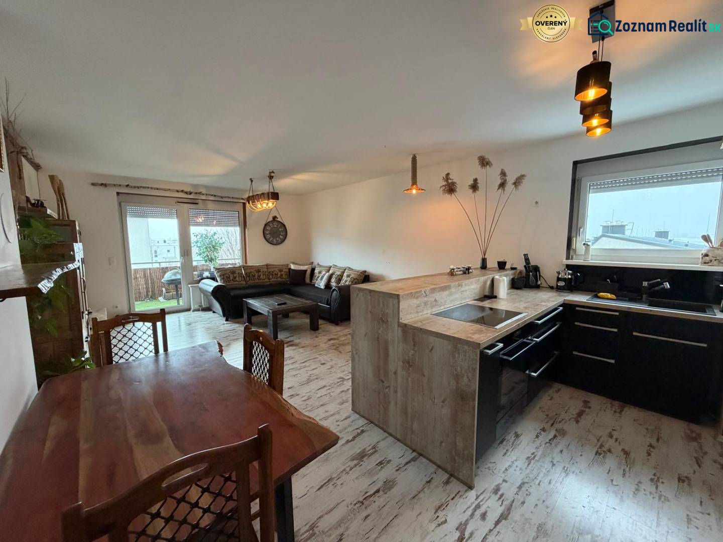 Living room with a kitchen in a 3-room apartment, floor with a wooden decor.