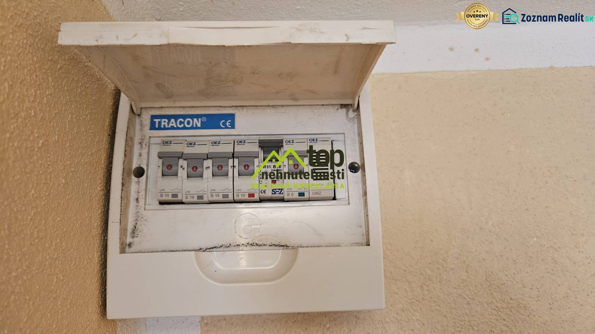 Electrical switchboard with circuit breakers in a studio apartment, mounted on the wall with a cover.