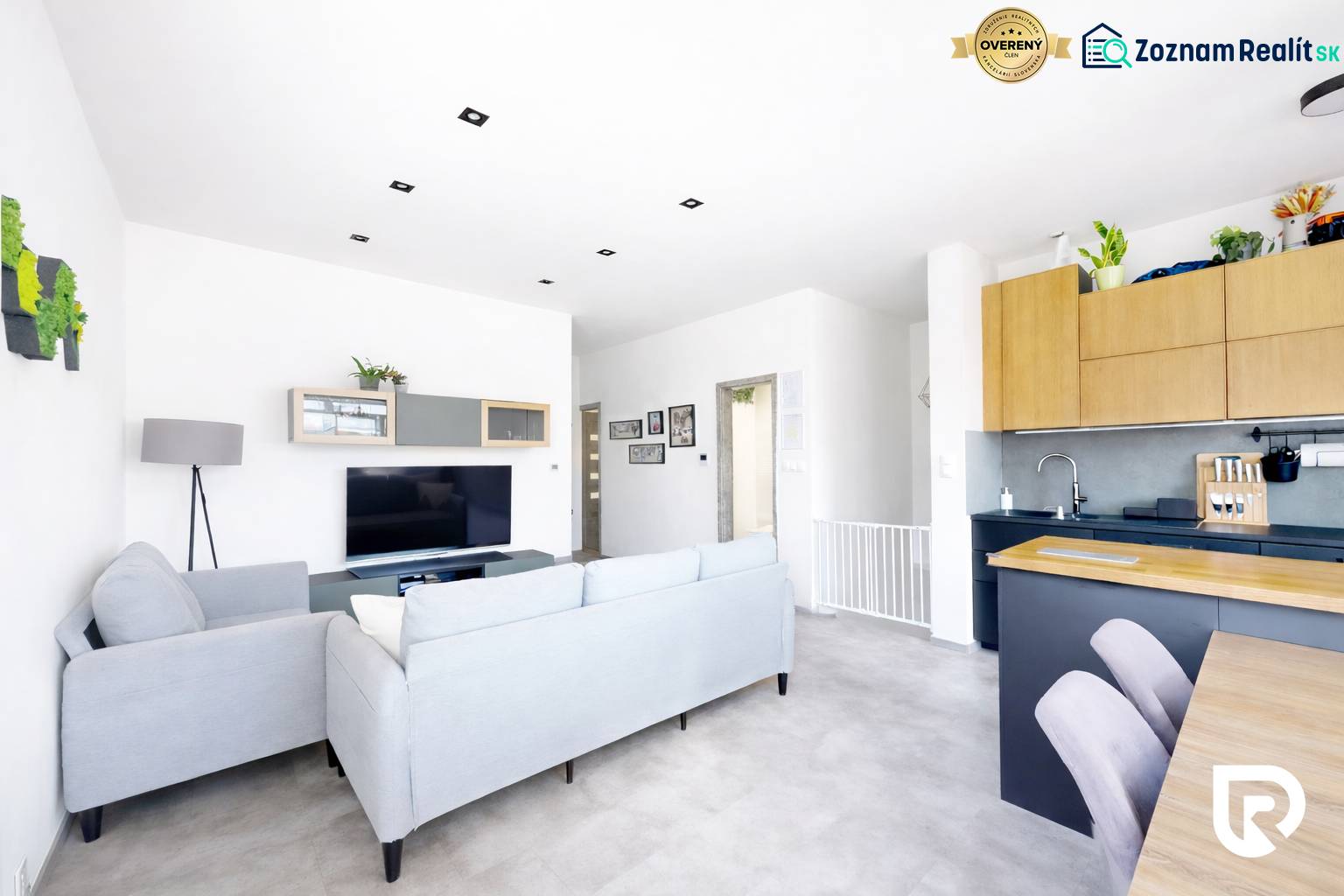 Bright living room in a 3-room apartment with a comfortable sofa and a television.