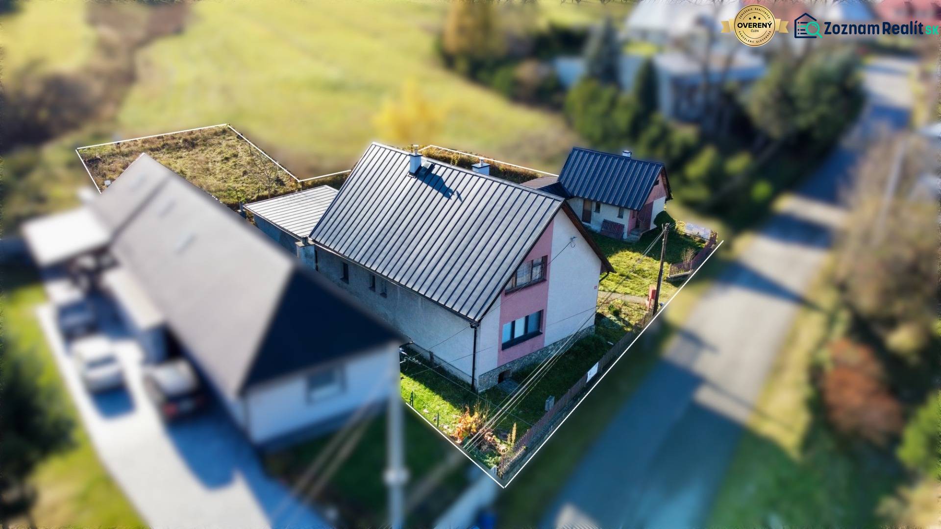 A family house in the village of Šarišské Čierne with a metal roof and a garden.