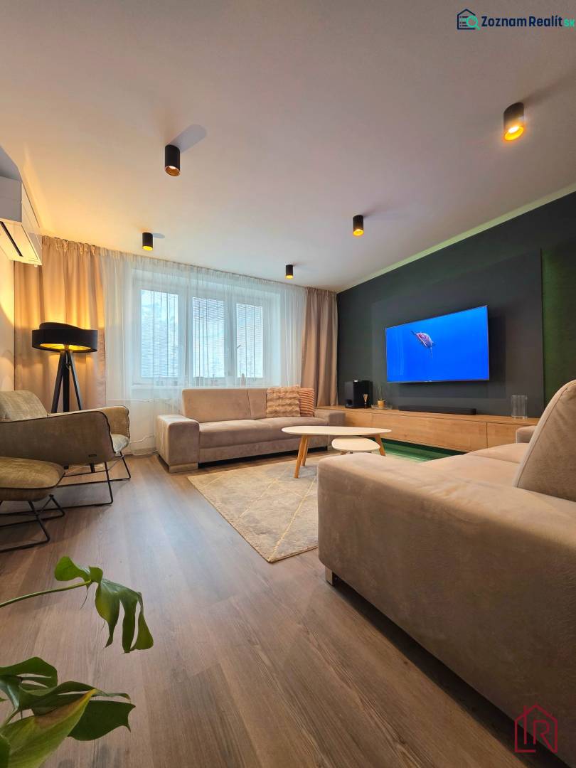 Living room in a two-room apartment with a comfortable sofa and a wooden decor floor.