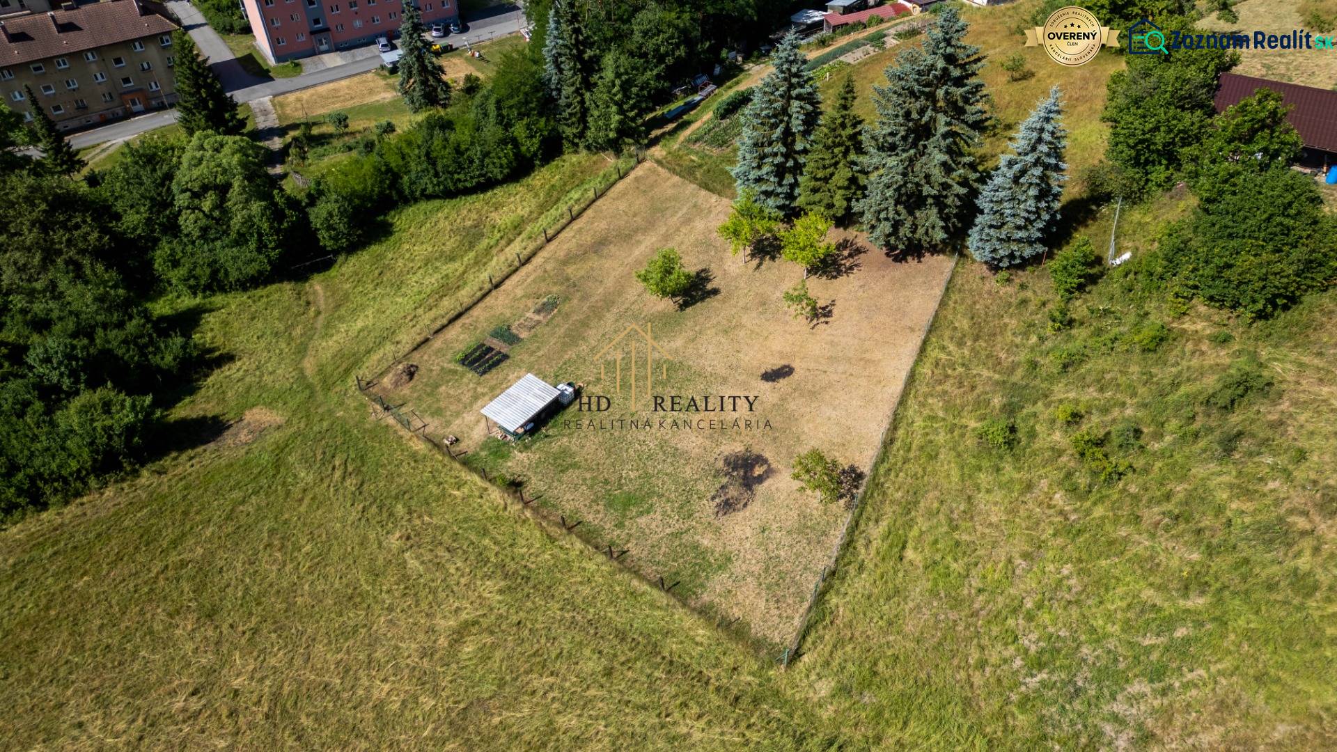 Land - housing in Banská Belá with surrounding buildings and greenery.