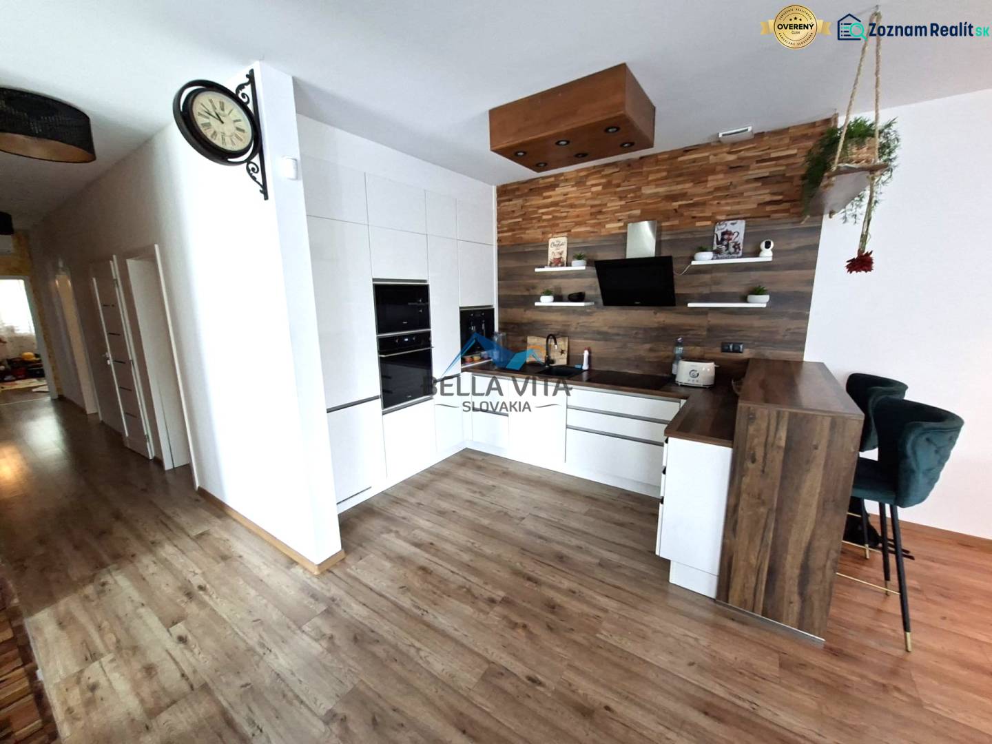 A kitchen in a family house with a wooden decor floor and modern kitchen equipment.